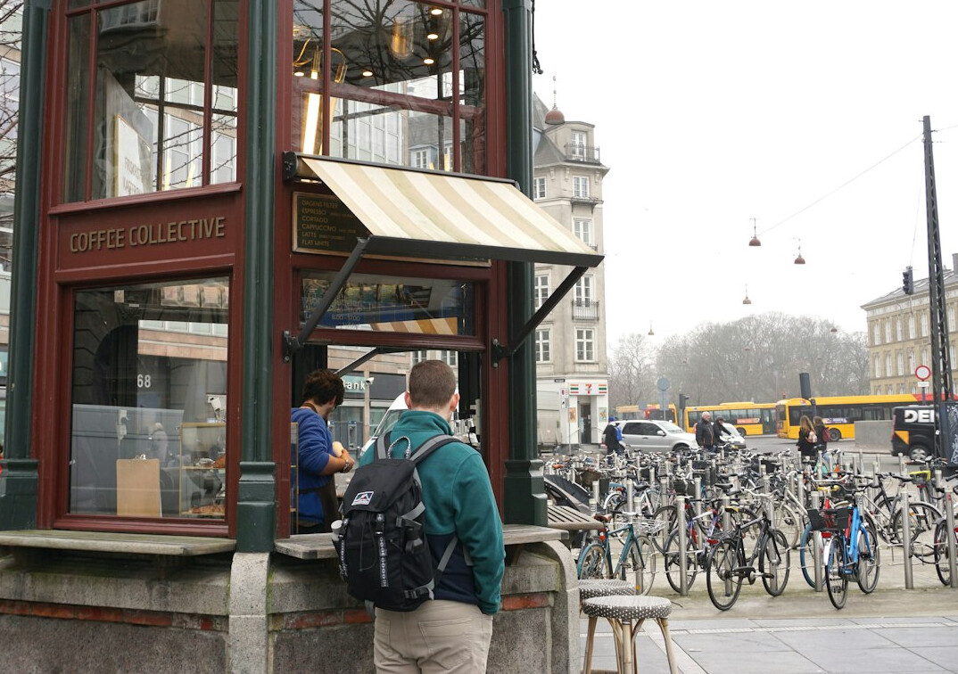 People queueing outside a Danish bakery in winter snow